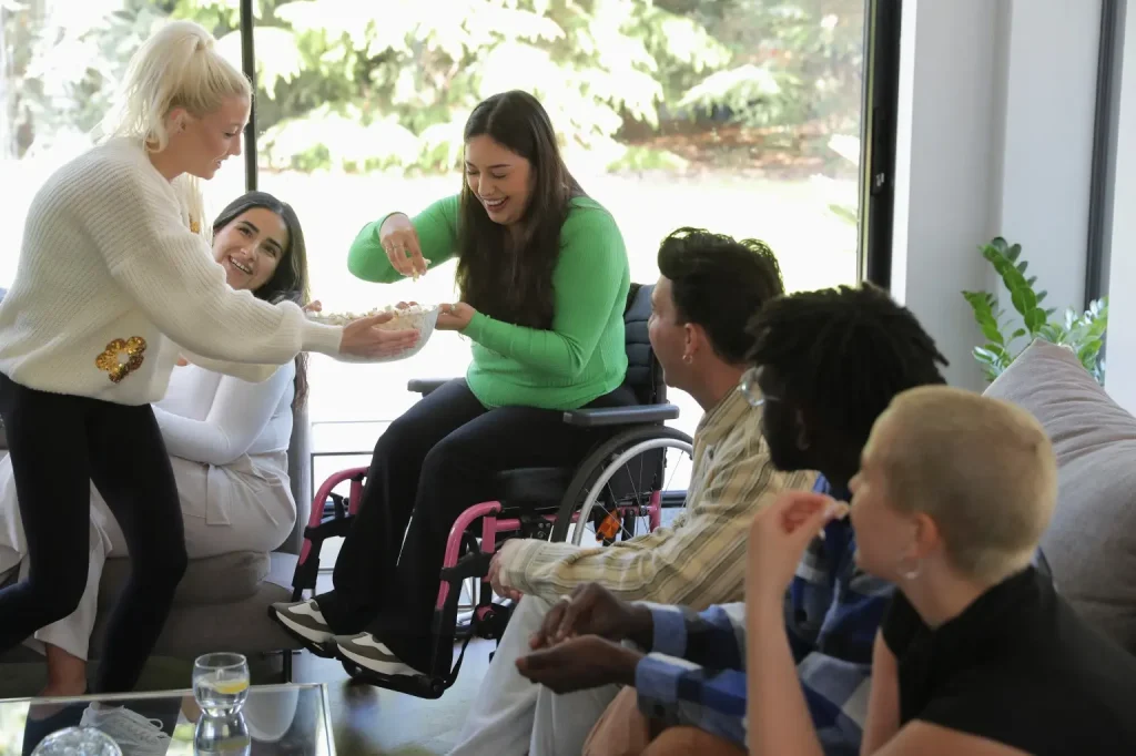 A group of friends are enjoying a movie and popcorn together