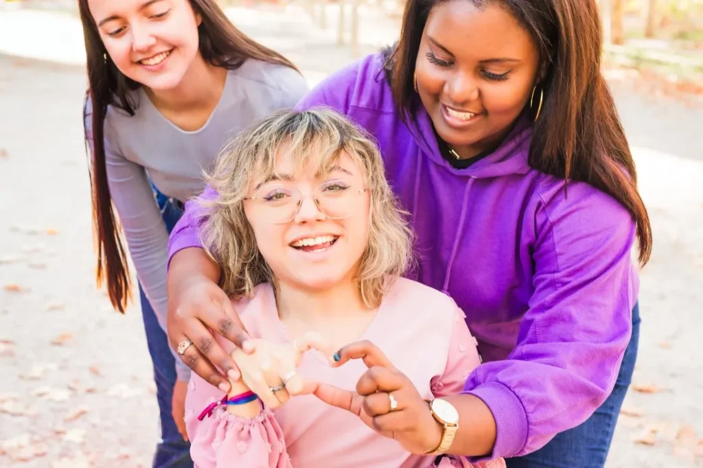 A group of disabled friends smiling together while outside